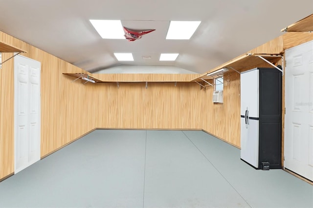 below grade area featuring wood walls and cooling unit