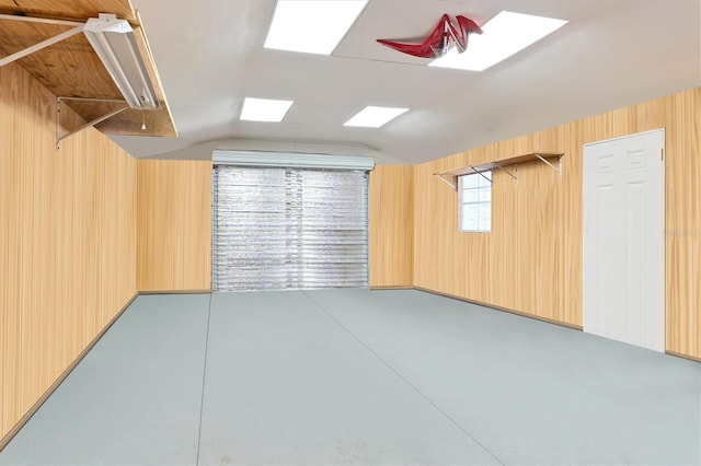 unfurnished room with lofted ceiling