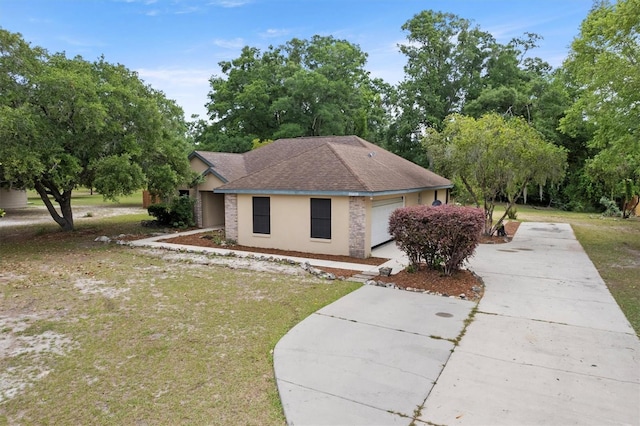 view of front of house with driveway, a front lawn, and stucco siding