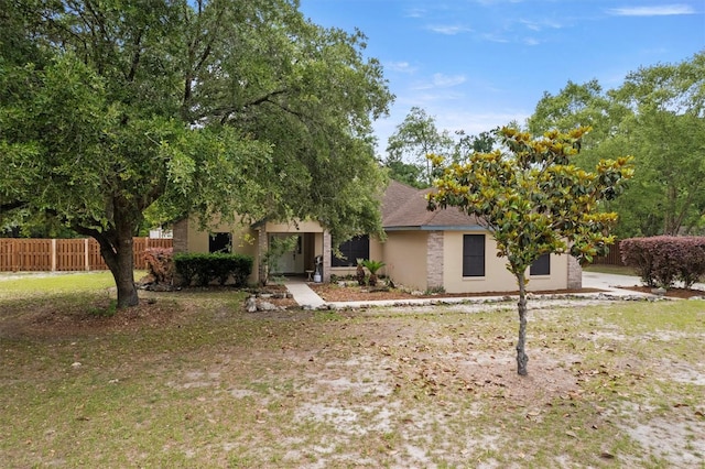 obstructed view of property featuring fence and stucco siding