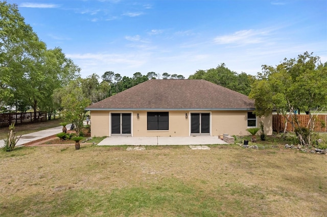 back of house with stucco siding, a patio area, and a shingled roof