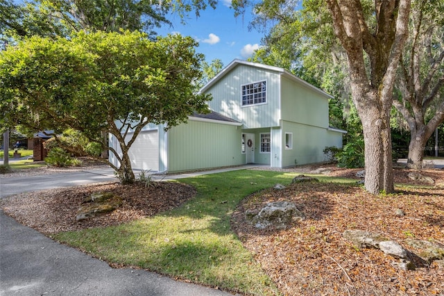 7202 NW 52nd Ter, Gainesville, FL 32653 - view of front facade with asphalt driveway, an attached garage, and a front lawn