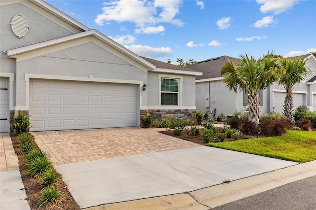5237 NW 48th Pl, Ocala, FL 34482 - view of front facade with stone siding, decorative driveway, stucco siding, and an attached garage