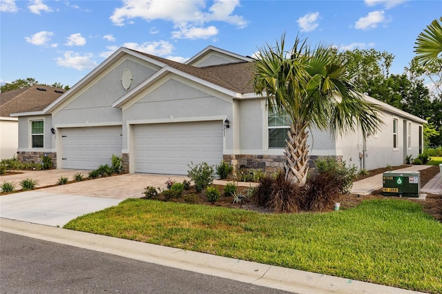 5237 NW 48th Pl, Ocala, FL 34482 - view of front of property with stone siding, driveway, stucco siding, a front yard, and an attached garage