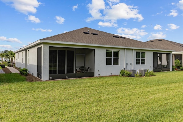 5237 NW 48th Pl, Ocala, FL 34482 - rear view of house with a sunroom, stucco siding, roof with shingles, and a yard