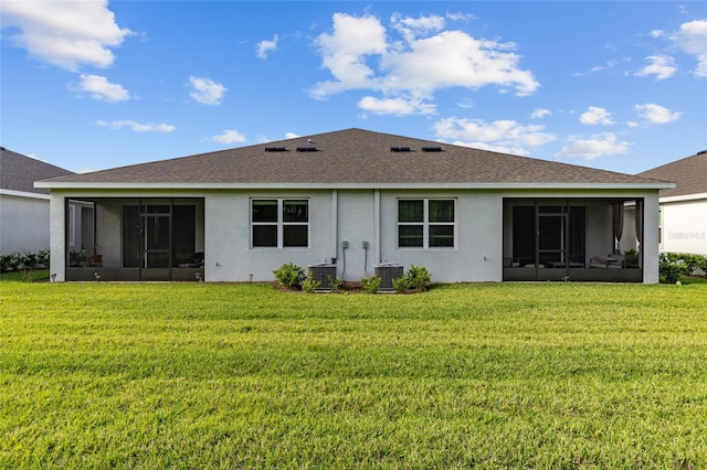 5237 NW 48th Pl, Ocala, FL 34482 - rear view of property featuring a sunroom, stucco siding, and a lawn
