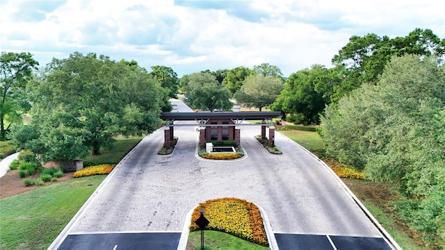 5237 NW 48th Pl, Ocala, FL 34482 - surrounding community with driveway, view of wooded area, and a yard