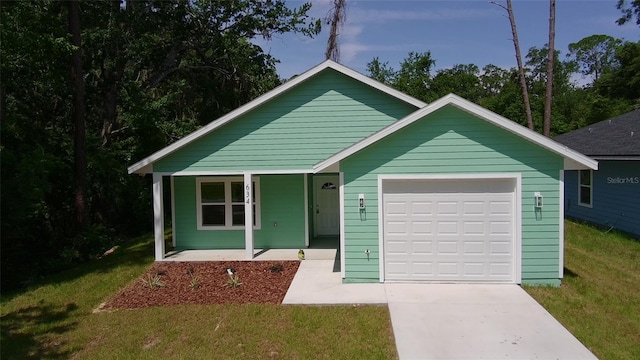 634 NE 15th Ter, Gainesville, FL 32641 - view of front facade with a porch, a garage, driveway, and a front lawn