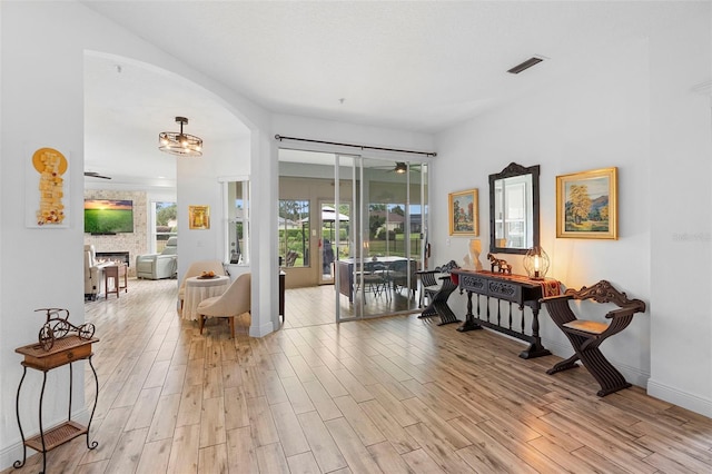 23510 Oak Prairie Cir, Sorrento, FL 32776 - hall with light wood-style floors, arched walkways, and baseboards