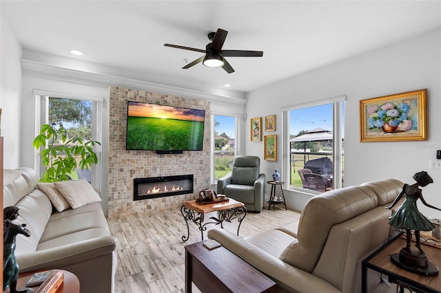 23510 Oak Prairie Cir, Sorrento, FL 32776 - living room featuring ceiling fan, light wood-style flooring, a brick fireplace, recessed lighting, and crown molding