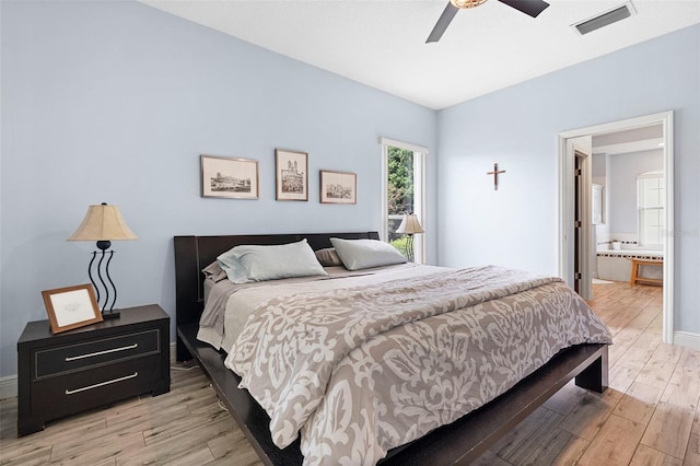 23510 Oak Prairie Cir, Sorrento, FL 32776 - bedroom featuring light wood-style floors, a ceiling fan, and ensuite bathroom