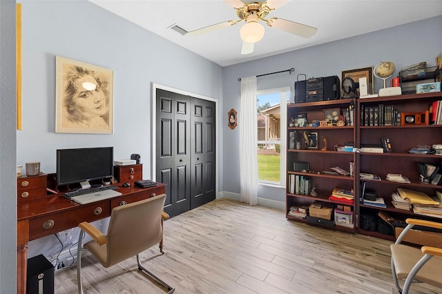 23510 Oak Prairie Cir, Sorrento, FL 32776 - home office with wood finished floors, a ceiling fan, and baseboards