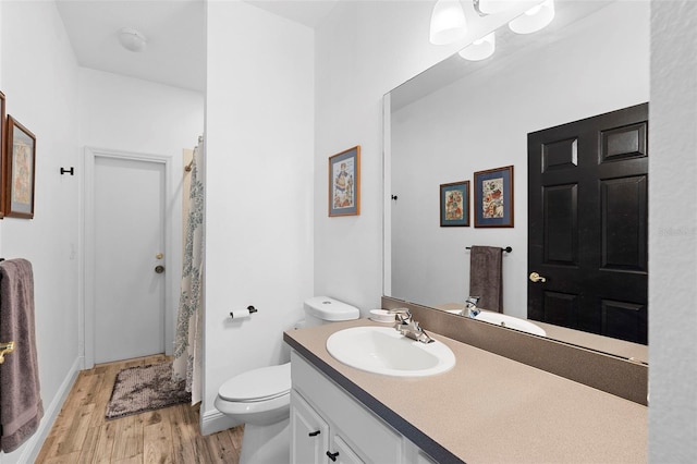 23510 Oak Prairie Cir, Sorrento, FL 32776 - bathroom with wood finished floors, vanity, toilet, a shower with curtain, and baseboards