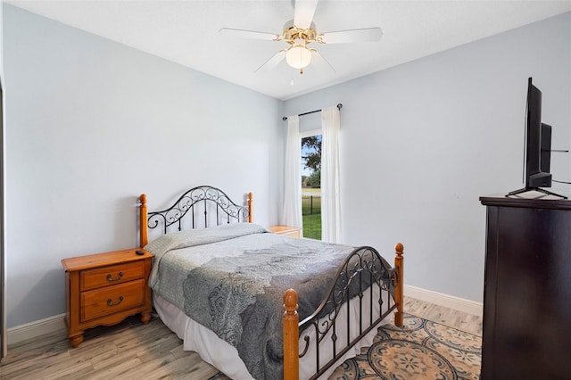 23510 Oak Prairie Cir, Sorrento, FL 32776 - bedroom with light wood-type flooring, baseboards, and a ceiling fan