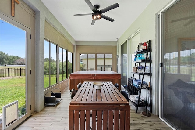 23510 Oak Prairie Cir, Sorrento, FL 32776 - sunroom / solarium with a hot tub, a ceiling fan, and wood finished floors