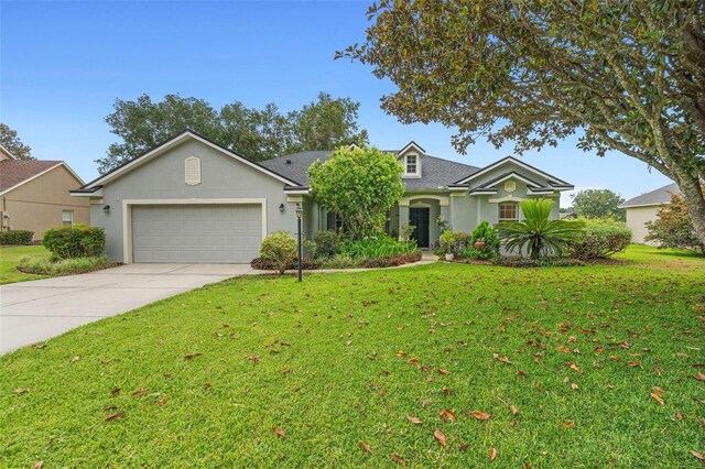 23510 Oak Prairie Cir, Sorrento, FL 32776 - view of front of house featuring concrete driveway, a garage, a front lawn, and roof with shingles