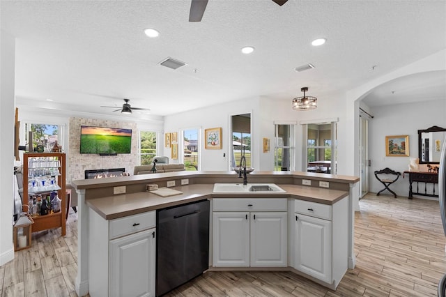 23510 Oak Prairie Cir, Sorrento, FL 32776 - kitchen with dishwasher, ceiling fan, a sink, open floor plan, and a textured ceiling