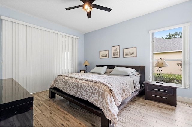 23510 Oak Prairie Cir, Sorrento, FL 32776 - bedroom with light wood finished floors, multiple windows, and a ceiling fan