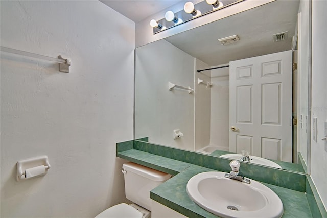full bathroom with toilet, a shower, and vanity