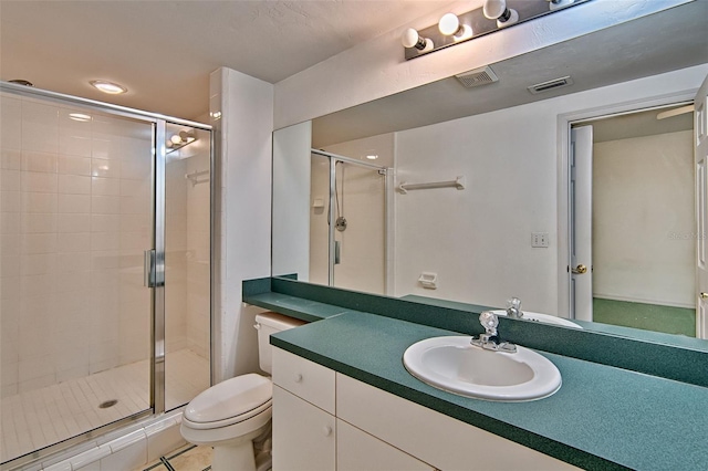 full bathroom with a shower stall, toilet, and vanity