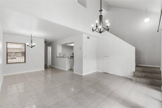 unfurnished living room with a chandelier, stairs, a high ceiling, a sink, and light tile patterned flooring