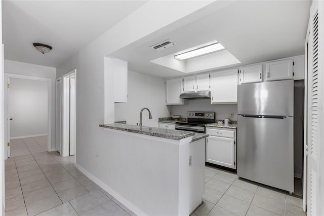 kitchen with appliances with stainless steel finishes, under cabinet range hood, light tile patterned floors, and white cabinets
