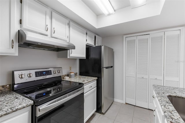 kitchen with appliances with stainless steel finishes, under cabinet range hood, white cabinetry, light tile patterned floors, and light stone counters