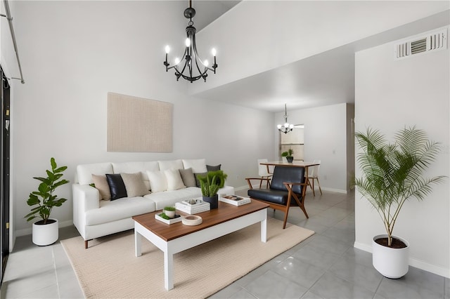 living area with a chandelier, baseboards, and light tile patterned floors