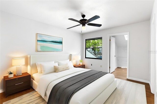 bedroom with wood finished floors, baseboards, and a ceiling fan