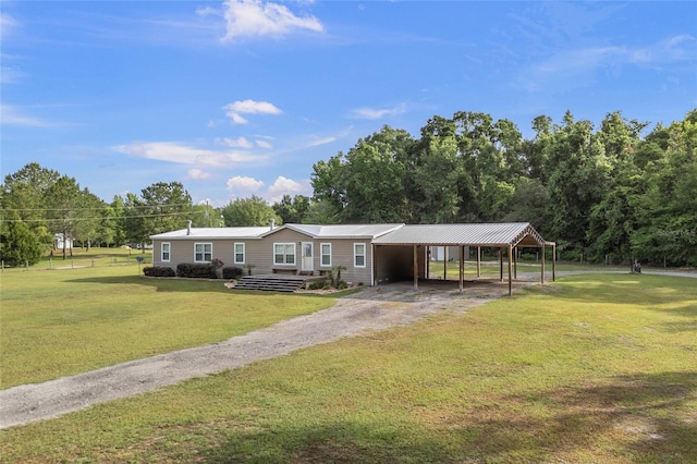 manufactured / mobile home with dirt driveway and a front yard