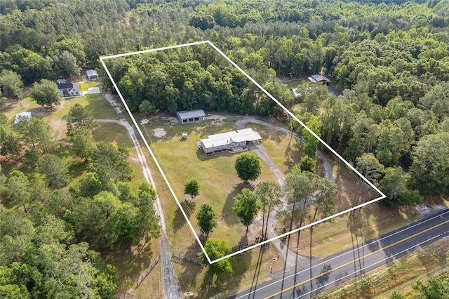 aerial view of property's location with a heavily wooded area and property boundaries highlighted