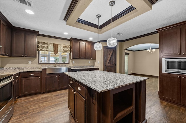 kitchen with a sink, stainless steel appliances, crown molding, open shelves, and dark wood finished floors