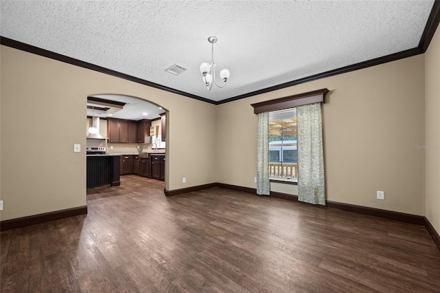 unfurnished living room with arched walkways, a chandelier, dark wood-style flooring, a textured ceiling, and ornamental molding