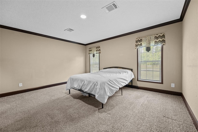 carpeted bedroom featuring ornamental molding, baseboards, and a textured ceiling
