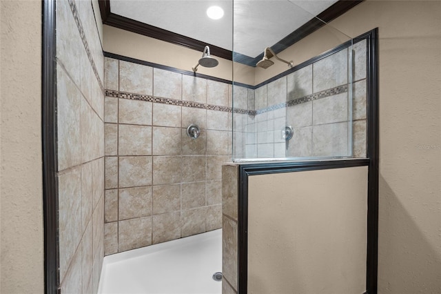 full bathroom featuring ornamental molding and a stall shower