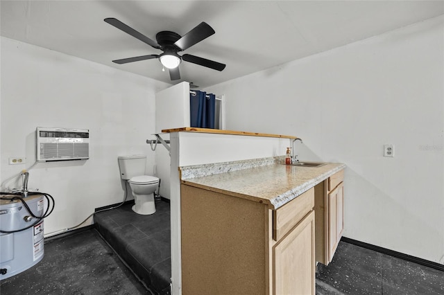 bathroom featuring an AC wall unit, toilet, a sink, electric water heater, and a ceiling fan