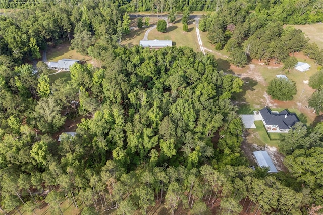 aerial view of property's location featuring a heavily wooded area
