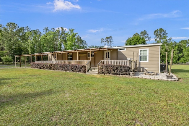 rear view of house with covered porch and a lawn