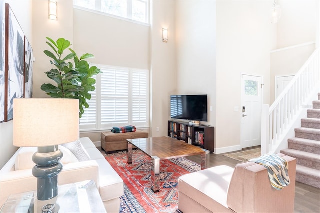 3242 NW 23rd Rd, Gainesville, FL 32605 - living area featuring a high ceiling, stairs, wood finished floors, and baseboards