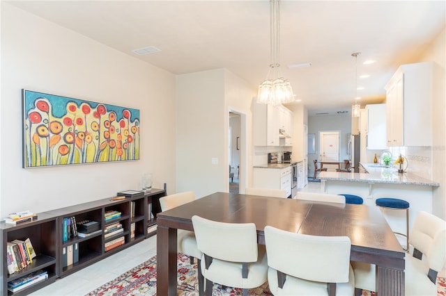 3242 NW 23rd Rd, Gainesville, FL 32605 - dining area featuring a chandelier and light tile patterned flooring
