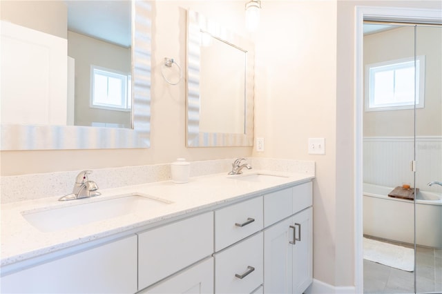 3242 NW 23rd Rd, Gainesville, FL 32605 - bathroom with double vanity, a tub, and tile patterned flooring