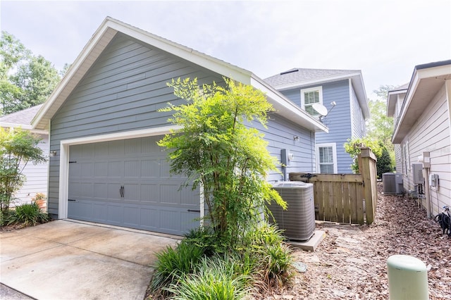 3242 NW 23rd Rd, Gainesville, FL 32605 - view of home's exterior with central air condition unit, fence, and driveway
