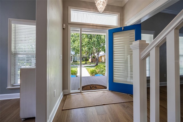 13209 SW 3rd Ln, Newberry, FL 32669 - foyer featuring a chandelier, wood finished floors, baseboards, and crown molding