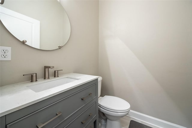 13209 SW 3rd Ln, Newberry, FL 32669 - bathroom featuring vanity, toilet, and baseboards