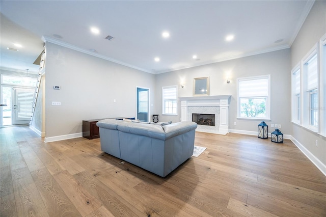 13209 SW 3rd Ln, Newberry, FL 32669 - living room with a fireplace, light wood-style floors, ornamental molding, baseboards, and recessed lighting