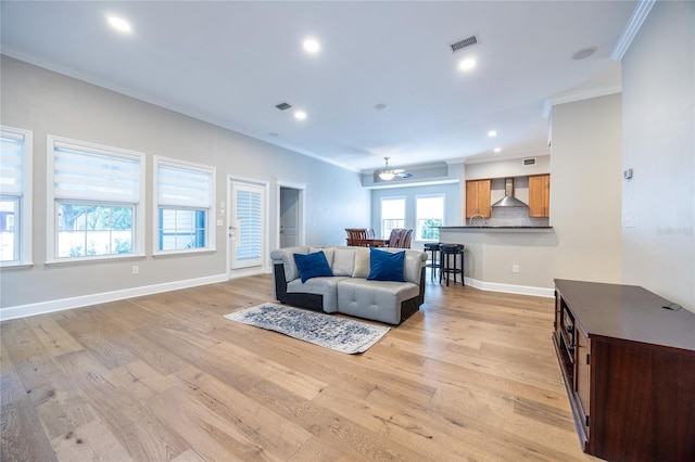 13209 SW 3rd Ln, Newberry, FL 32669 - living room featuring crown molding, light wood-style flooring, baseboards, and recessed lighting