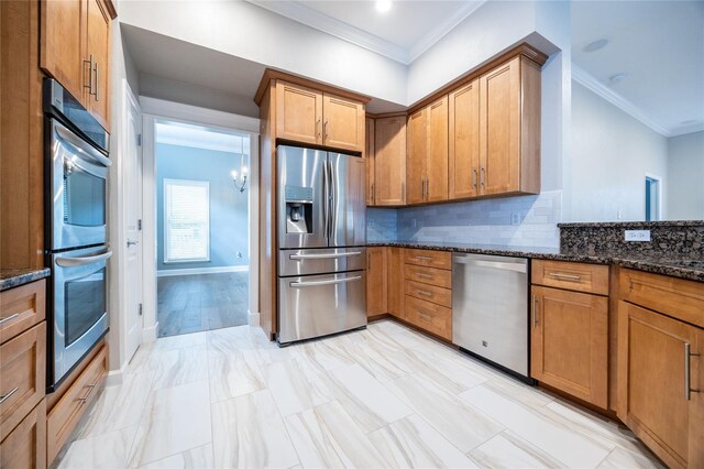 13209 SW 3rd Ln, Newberry, FL 32669 - kitchen featuring stainless steel appliances, ornamental molding, dark stone countertops, tasteful backsplash, and brown cabinetry