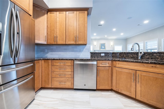13209 SW 3rd Ln, Newberry, FL 32669 - kitchen featuring appliances with stainless steel finishes, a sink, dark stone counters, backsplash, and light marble finish floors