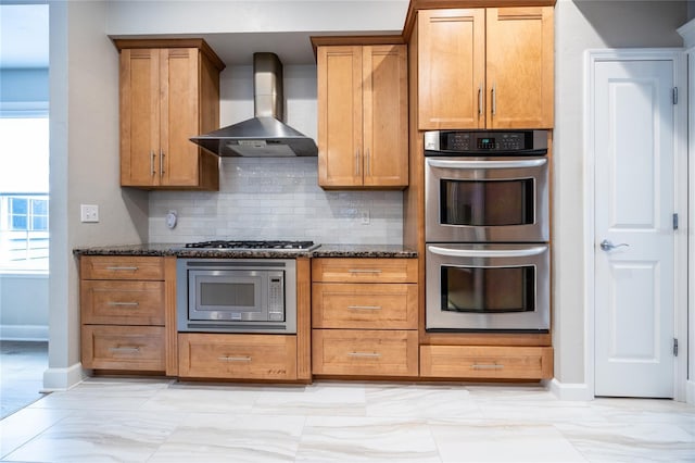 13209 SW 3rd Ln, Newberry, FL 32669 - kitchen with appliances with stainless steel finishes, wall chimney range hood, baseboards, tasteful backsplash, and dark stone countertops
