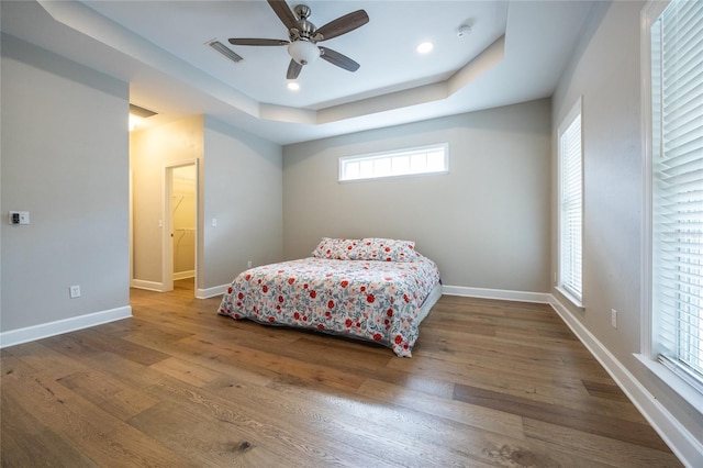 13209 SW 3rd Ln, Newberry, FL 32669 - bedroom with a raised ceiling, multiple windows, wood finished floors, and recessed lighting